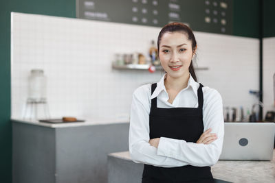 Portrait of smiling barista at cafe