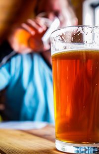 Close-up of beer glass on table