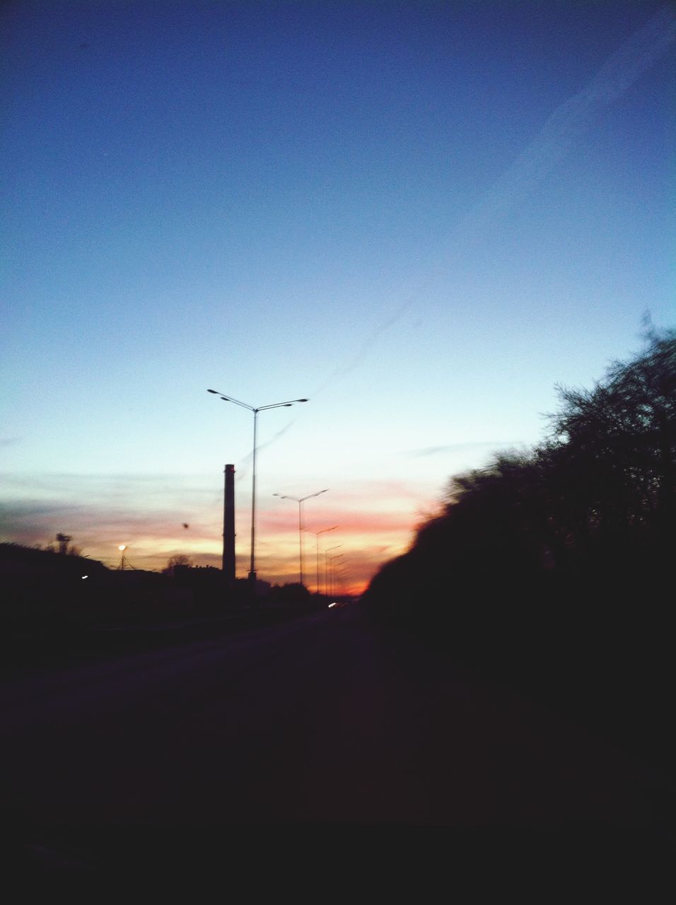 transportation, sunset, road, silhouette, sky, the way forward, road marking, clear sky, landscape, copy space, tree, diminishing perspective, country road, dusk, street, car, blue, tranquility, nature, street light