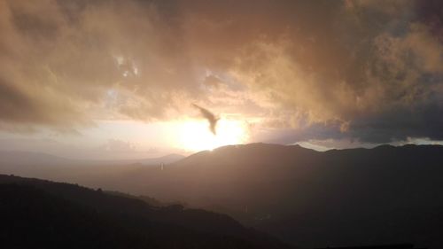 Scenic view of silhouette mountain against sky during sunset