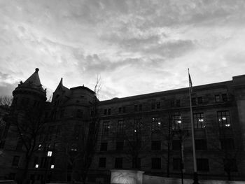 Low angle view of building against cloudy sky