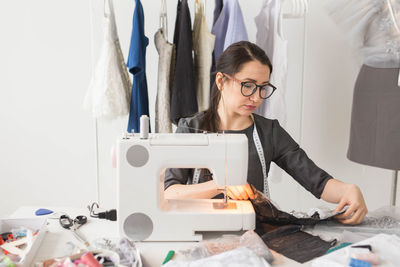 Mid adult woman wearing eyeglasses on table