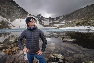 Portrait of man standing against mountain