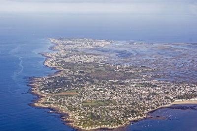 Aerial view of sea against blue sky