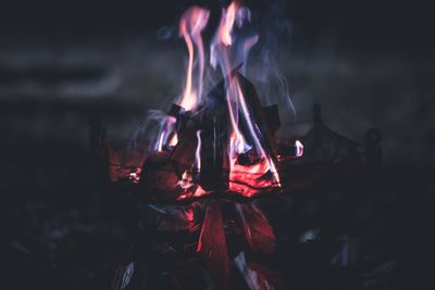 Close-up of fire on pit at night