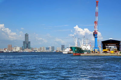 Scenic view of sea by buildings against sky