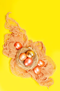 High angle view of eggs against yellow background