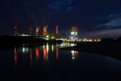 River with illuminated built structures in distance