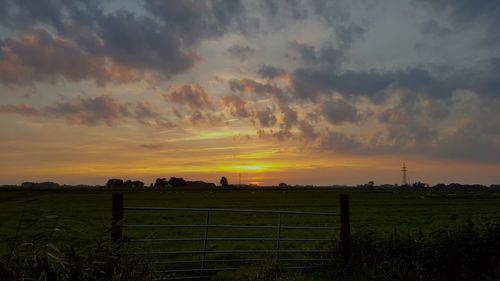 Scenic view of landscape against sky at sunset