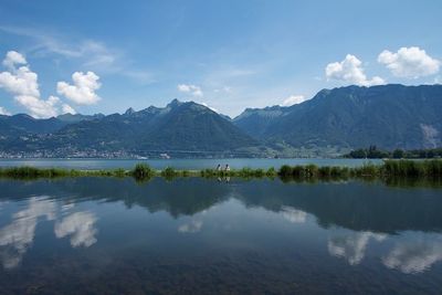 Scenic view of lake against cloudy sky