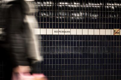 Blurred motion of person by metal grate