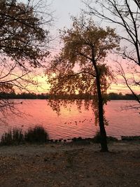 Scenic view of lake against sky at sunset
