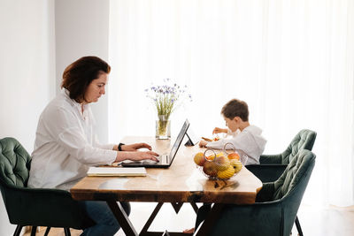 Female friends using digital tablet at home