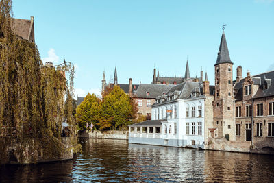 River amidst buildings against clear sky