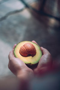 Close-up of hand holding strawberry