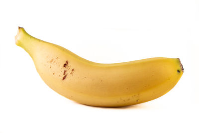 Close-up of yellow fruit against white background