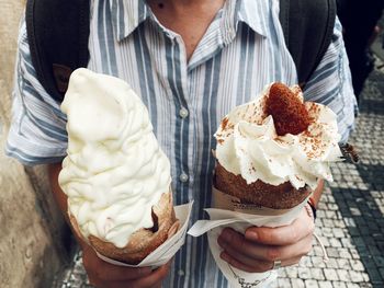 Midsection of woman holding ice cream