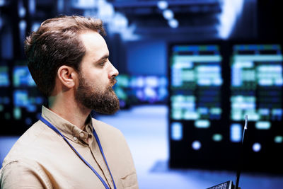 Side view of young man looking at airport