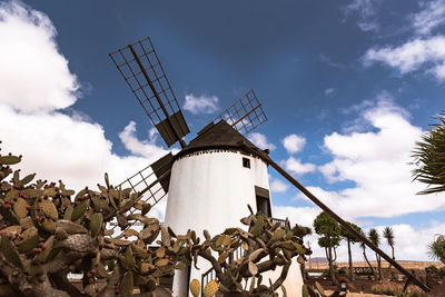 Low angle view of traditional windmill against sky