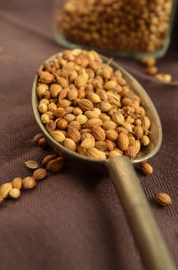 Close-up of coriander seeds in spoon on table