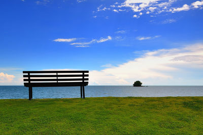 Lifeguard hut on sea against blue sky