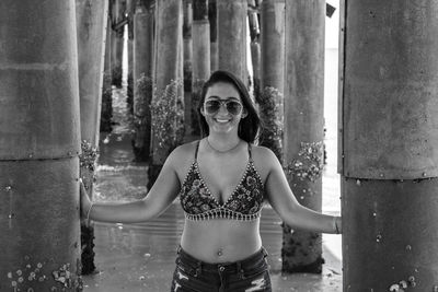 Woman standing below pier at beach