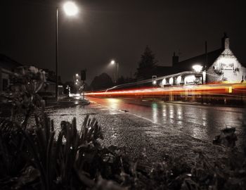 Light trails on wet street at night