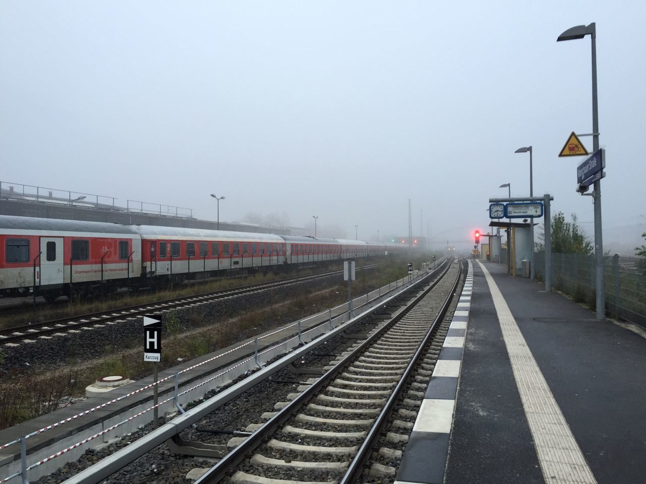 railroad track, transportation, rail transportation, public transportation, railroad station platform, railroad station, the way forward, train - vehicle, diminishing perspective, clear sky, sky, vanishing point, railway track, built structure, travel, street light, mode of transport, building exterior, architecture, public transport