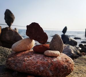 Close-up of rocks on beach against sky