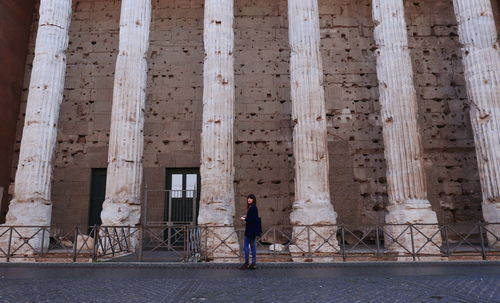 Woman standing in front of historical building