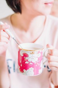 Midsection of woman drinking glass