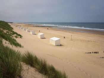 Panoramic view of north sea beach in domburg, zeeland, the netherlands with beach cabins against sky