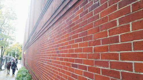Woman standing against wall