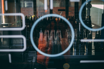 View of glasses seen through window at bar