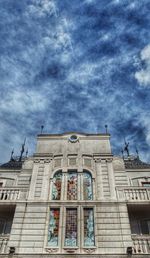 Low angle view of building against cloudy sky