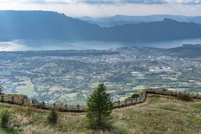 High angle view of townscape by mountain against sky