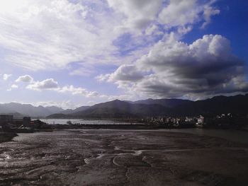 Scenic view of mountains against cloudy sky