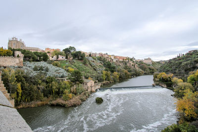 River amidst trees against sky