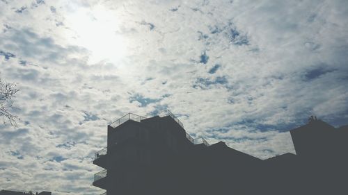 Low angle view of built structure against cloudy sky