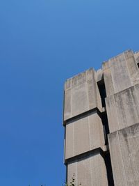 Low angle view of modern building against clear blue sky