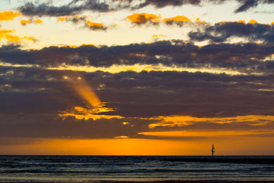 Scenic view of sea against orange sky