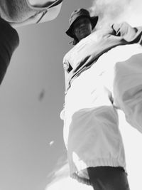 Low angle view of woman standing against wall