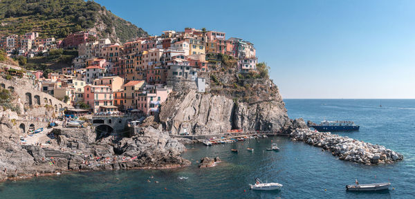 Panoramic view of sea and buildings against sky