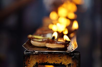 Close-up of lit candles at night