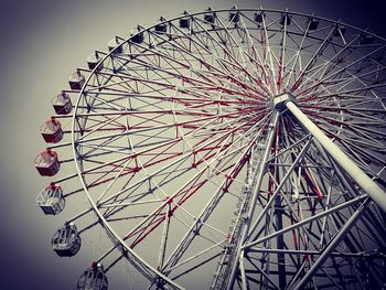 Low angle view of ferris wheel against sky