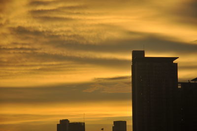 Low angle view of silhouette buildings against sky during sunset