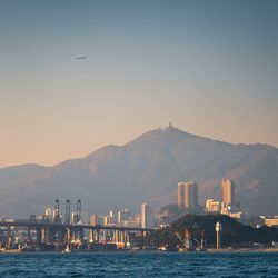 City by sea against clear sky