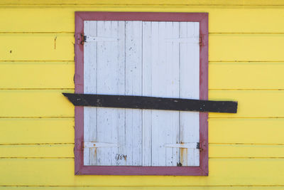 Closed door of yellow building