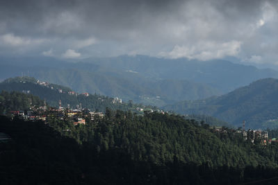 Panoramic view of illuminated mountains against sky at night