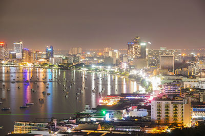 High angle view of illuminated buildings against sky at night